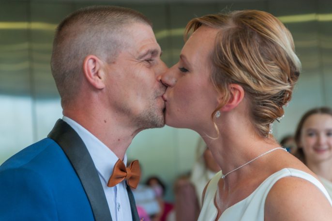 Un couple s'embrassant tendrement lors de leur mariage.